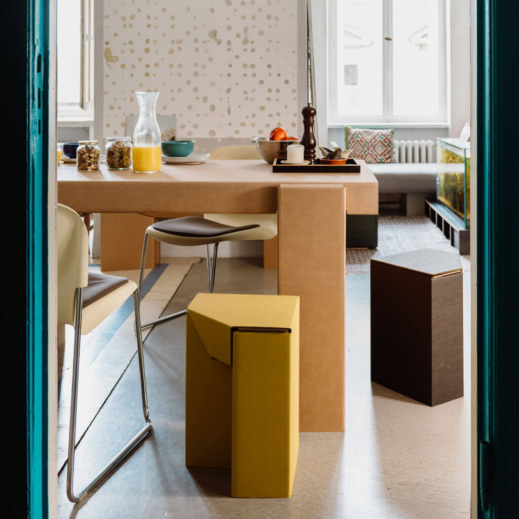 RIAB cardboard stool nightstand in yellow and black at kitchen table